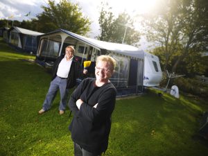 Older couple smiling outside R.V.