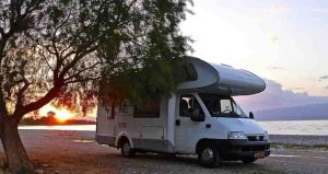 Caravan-RV Next to a Tree