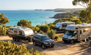 Modern caravans and a luxury motorhome parked at a scenic Australian coastal campsite with people relaxing.